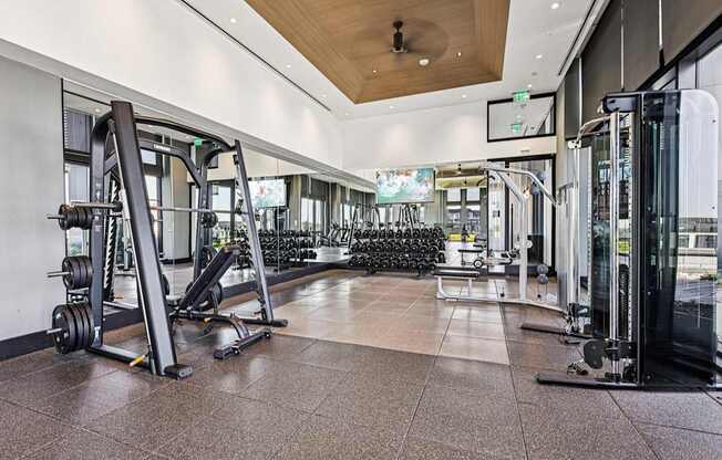 A gym with a variety of equipment including a leg press machine.
