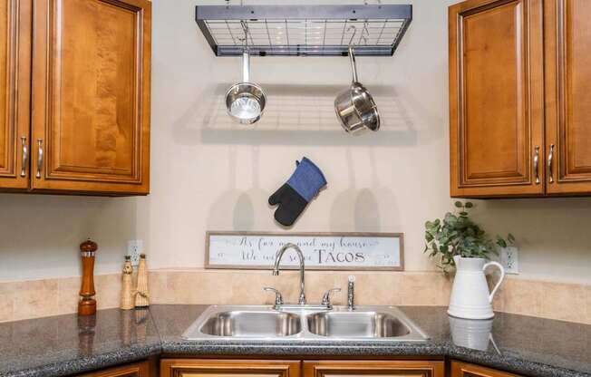 A kitchen with a sign that says "My corner and my tacos" above the sink.