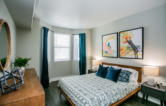 Octave Apartments a bedroom with a bed and two paintings on the wall at Octave Apartments, Nevada, 89123