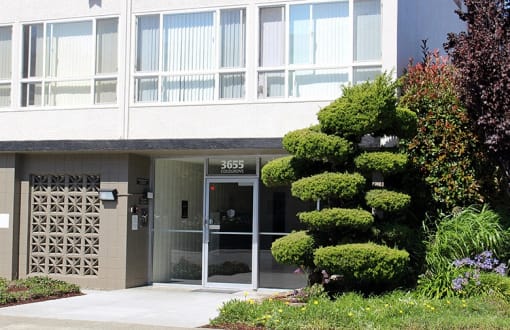 The glass entrance walkway leading to 3655 Colegrove apartments