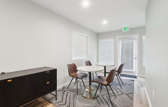 A conference room with a table and chairs.