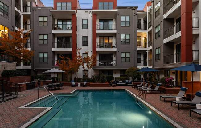 A swimming pool in front of apartment buildings.