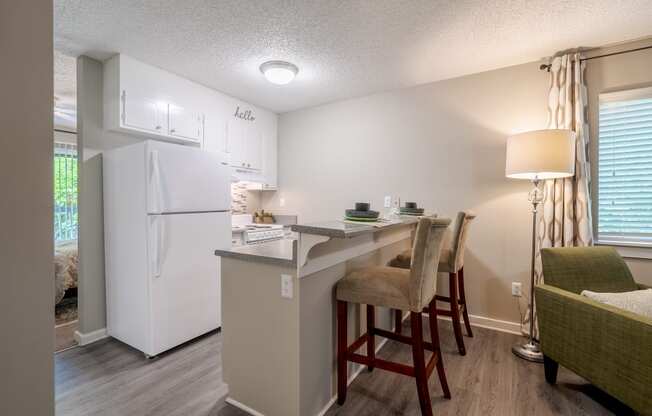 a kitchen with a breakfast bar and a white refrigerator