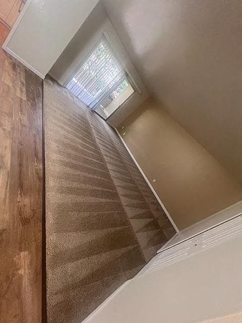 a hallway with a glass door and a window