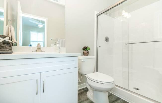 a white bathroom with a shower and a toilet