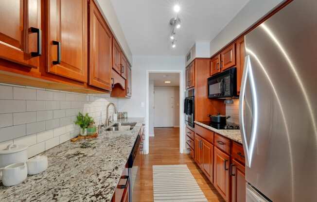 a kitchen with granite counter tops and wooden cabinets