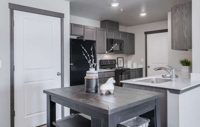 Dining area looking into Kitchen. Dining area has a small bar stool table and chairs. at Altitude, East Wenatchee, WA