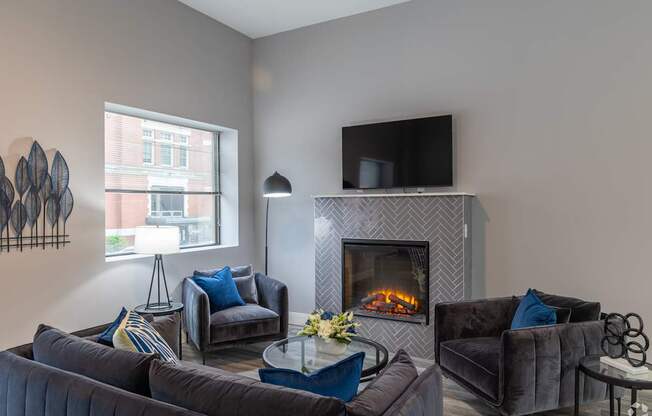 A living room with a fireplace and a television.
