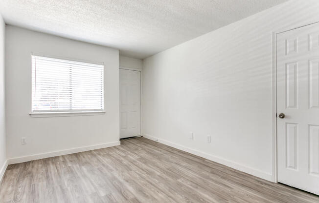 a bedroom with a door and a window