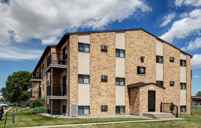 the exterior of a three level apartment. Fargo, ND Westwood Apartments