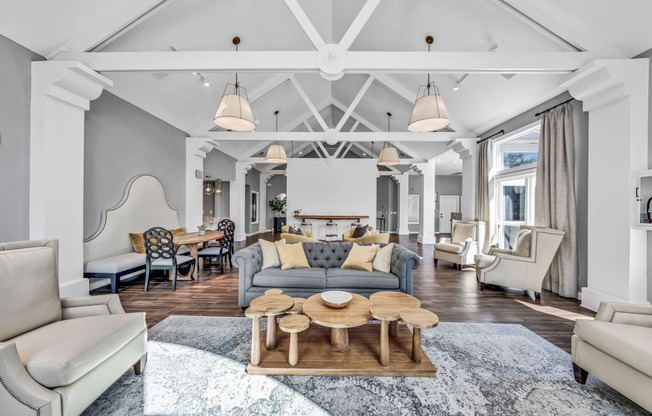 a living room with couches and chairs and a table