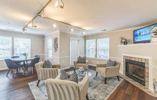 a living room with a fireplace and a table and chairs at Sanger Place, Virginia, 22079