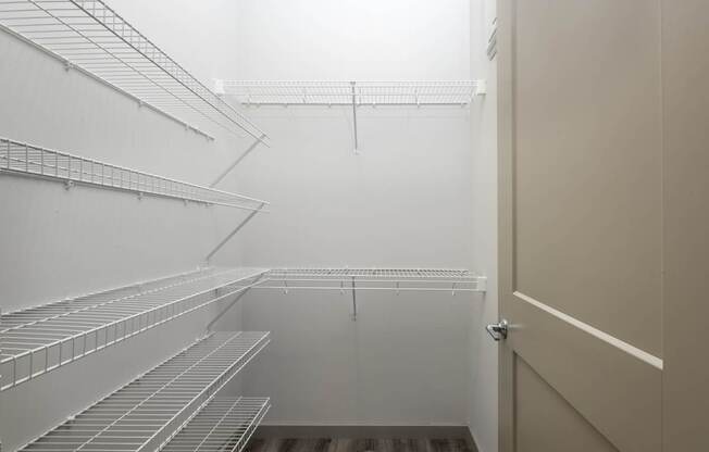 Empty white shelves in a room.