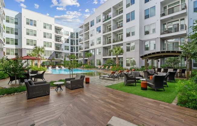 Courtyard with seating, greenspace and a pool at Harlow River Oaks in Houston, TX