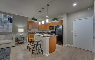 A kitchen with a refrigerator, microwave, and oven. at Vue Greenville, Texas