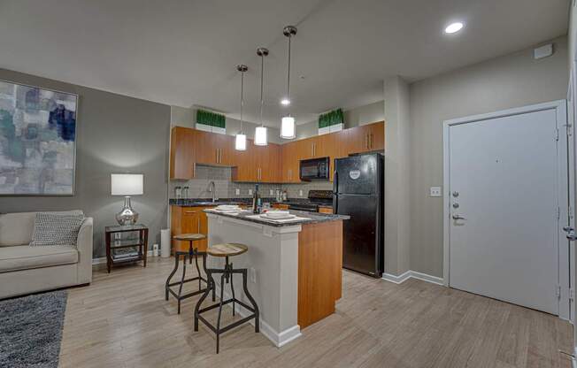 A kitchen with a refrigerator, microwave, and oven. at Vue Greenville, Texas