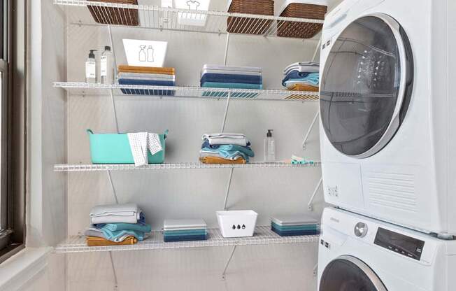 a laundry room with a washing machine and shelves