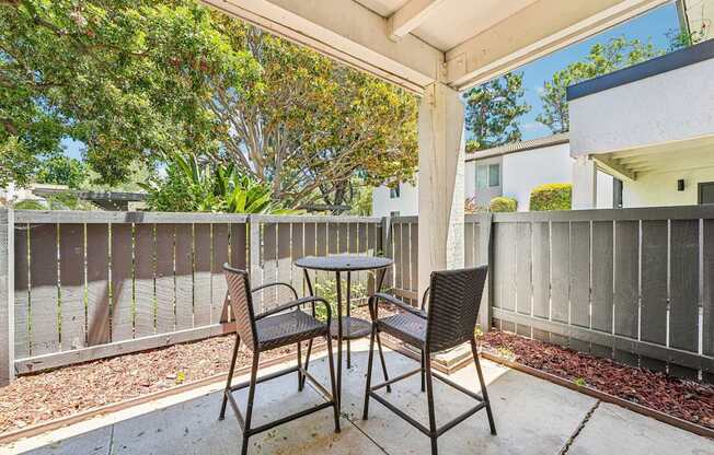 A patio with a table and two chairs.