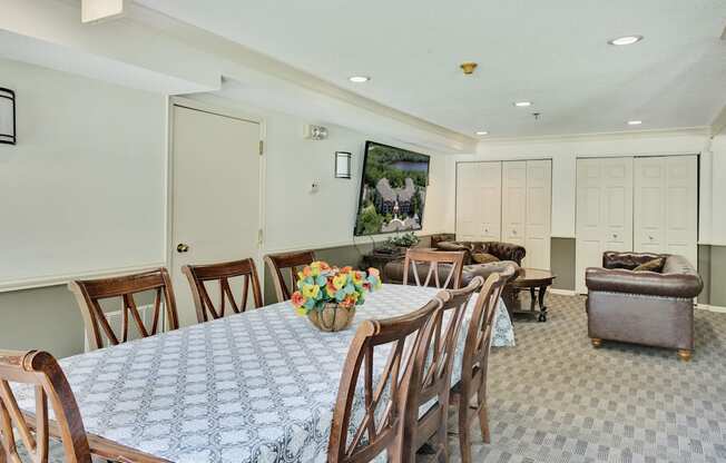 a dining room with a table and chairs and a living room with couches