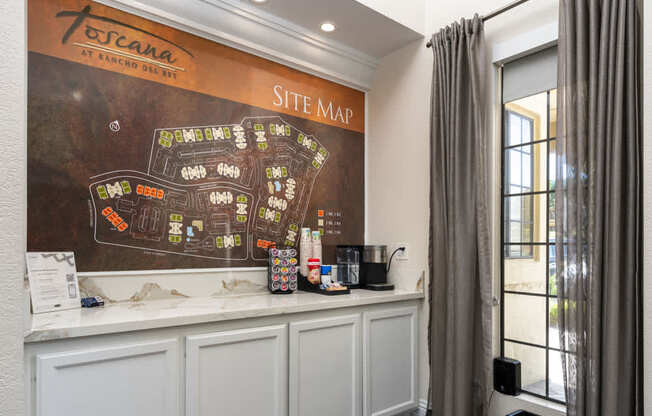 A site map is displayed on a wall above a reception desk.