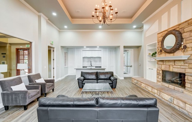 a living room with leather couches and a fireplace