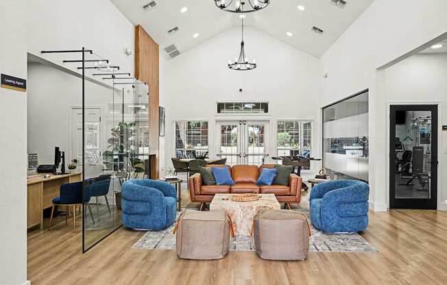 A modern living room with a glass wall and a brown sofa.