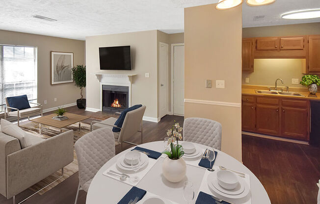 a dining area with a table and chairs and a fireplace in the background