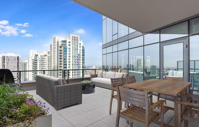 a balcony with a table and chairs and a view of the city at Cassidy on Canal, Chicago, Illinois, 60606