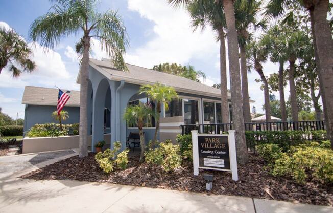 Beautiful building exterior of Park Village- blue and white buildings with palm trees