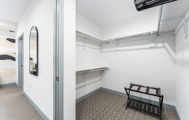 a white room with a bench and a glass door