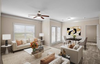 A licving room with a ceiling fan, lots of windows for natural lighting, crown molding and a dining area.