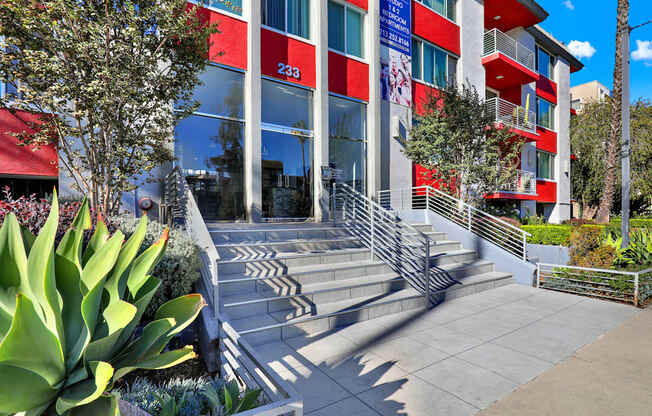 A red and white building with a staircase leading to the entrance.