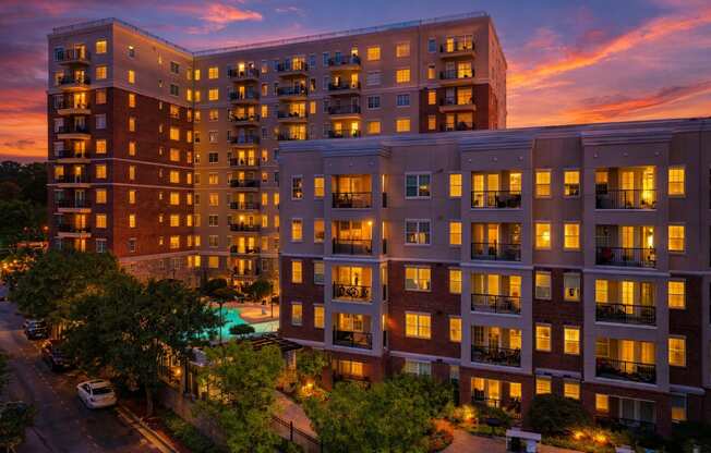 A large apartment complex with a pool in the courtyard.