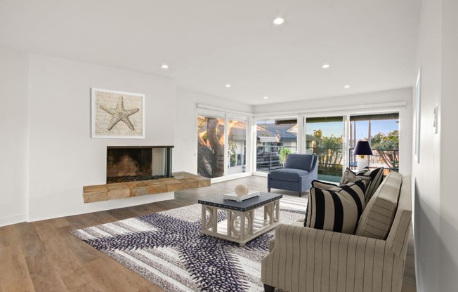 a living room with a fireplace and sliding glass doors