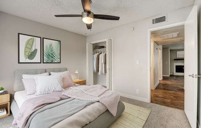 a bedroom with a large bed and a ceiling fan