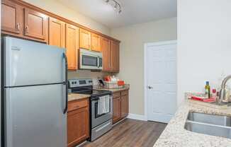 a kitchen with stainless steel appliances and granite counter tops