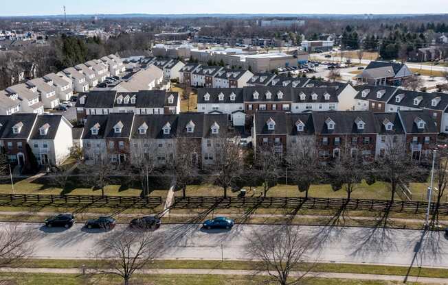 an aerial view of a neighborhood of houses with cars parked at Traditions at Slate Ridge, Reynoldsburg, 43068