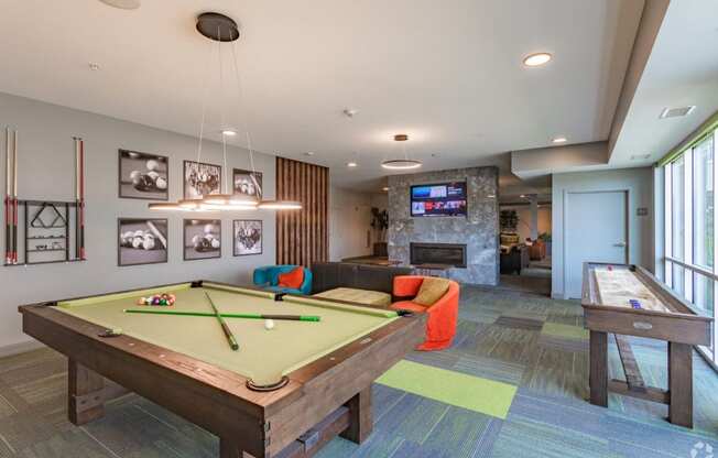 a games room with a pool table and a tv