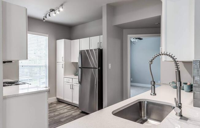 a kitchen with a sink and a mirror