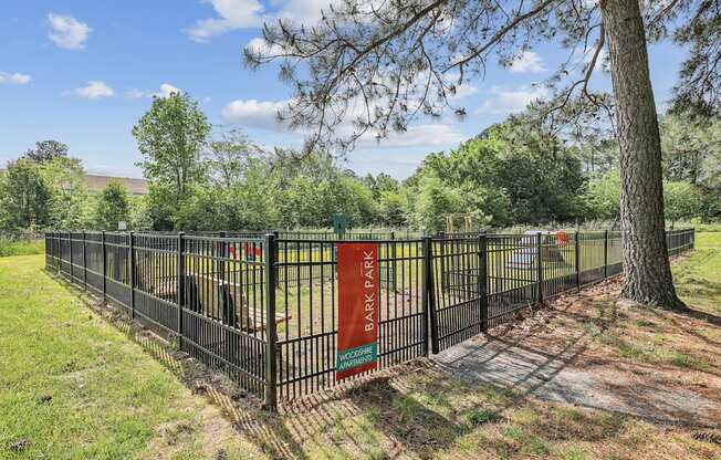 a park with a fence and a tree