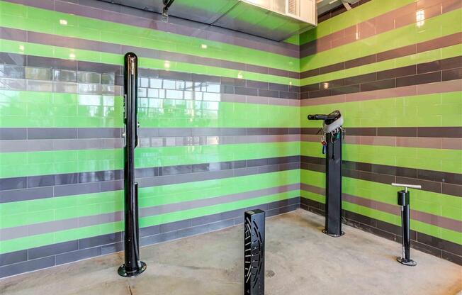 Bicycle maintenance and wash station at Circa Central with black and green striped walls