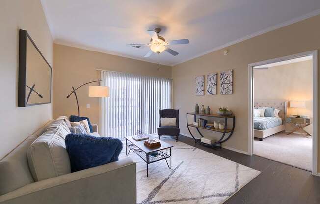 A living room with a grey couch and a black metal coffee table.