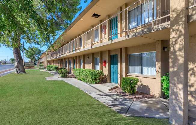 A row of apartment buildings with blue doors and windows.