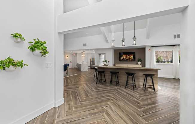 a living room with a fireplace and a table with bar stools