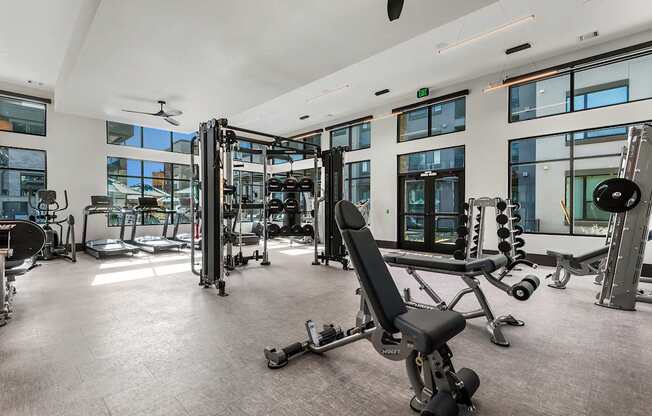 A spacious gym with a variety of equipment including treadmills, weights, and exercise machines.