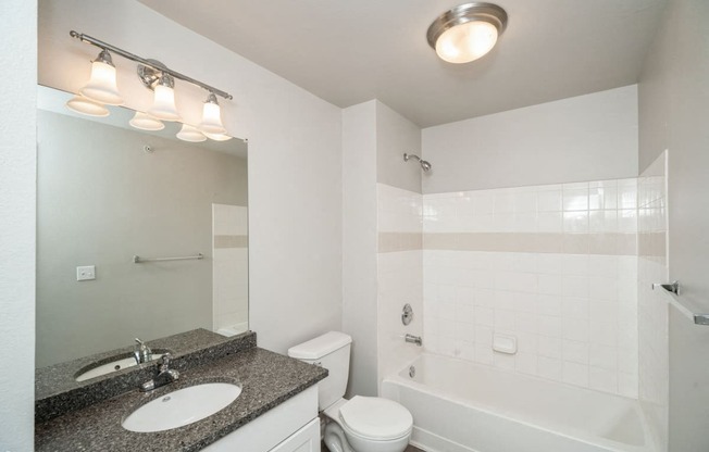 a bathroom with a sink toilet and a bath tub