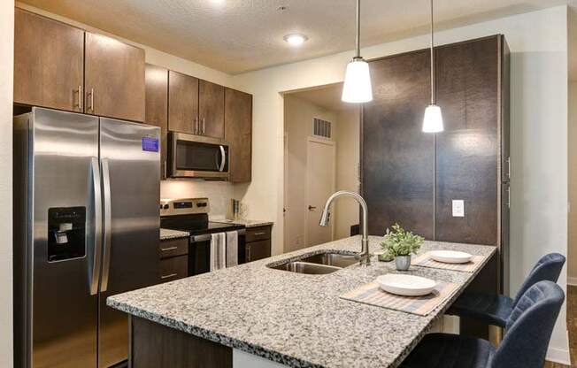 a kitchen with a sink a stove and a refrigerator  at Fusion, Florida