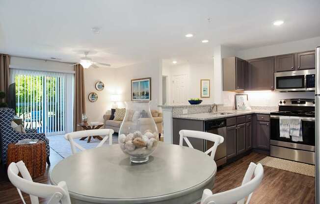 A modern kitchen with a dining table and chairs.