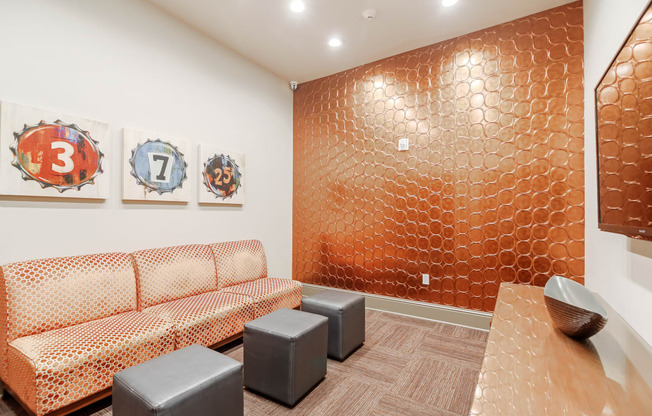 a room with couches and a table and paintings on the wall at Cumberland Place Apartment Homes, Tyler