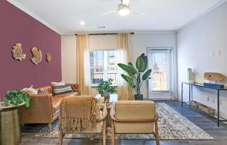 A living room with a brown chair and a brown couch.